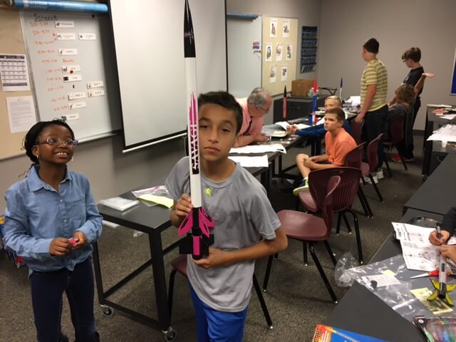 Student holding rocket.